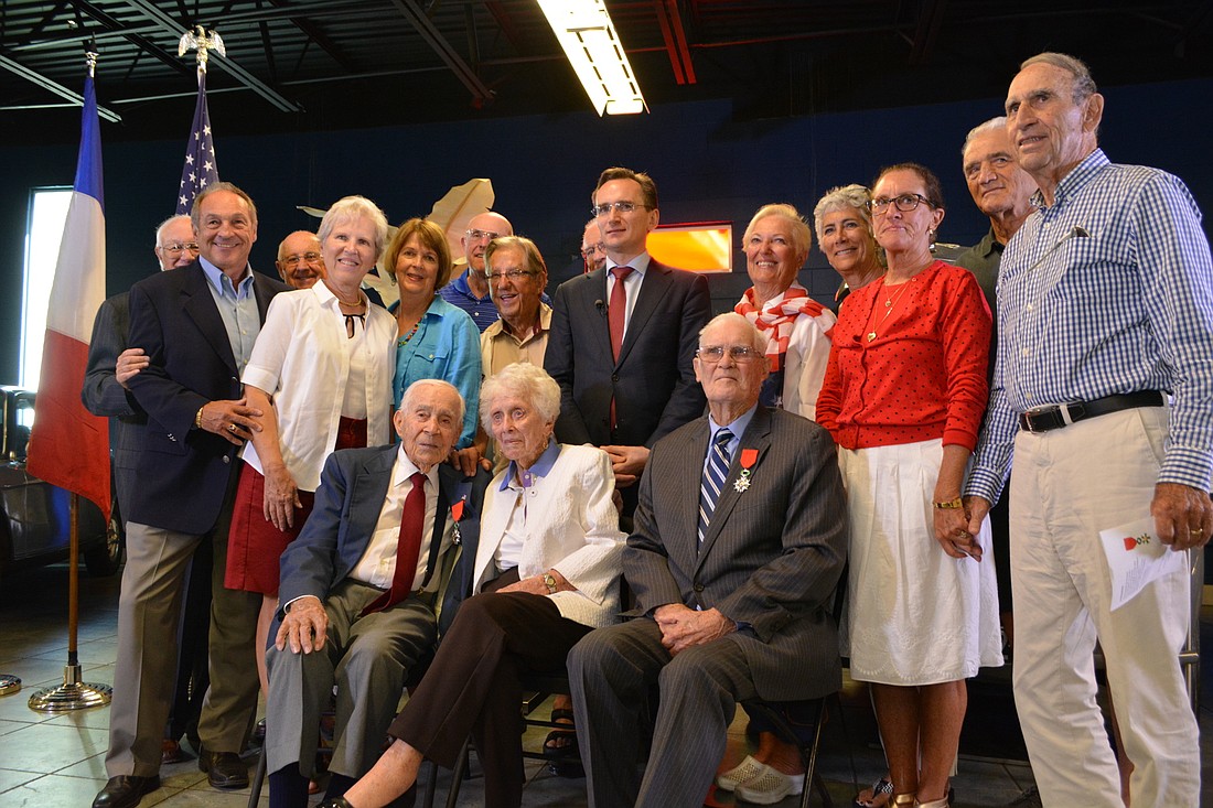 Friends from Palm Aire gather around Gus and Betty Andreone, front left and middle, and fellow award recipient Harold Stephens, of Ocala, seated right.