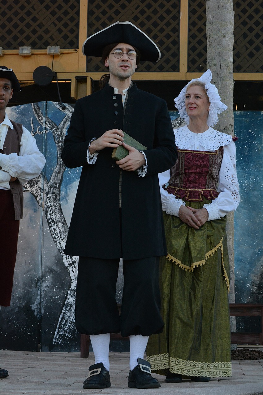 The new schoolmaster, Ichabod Crane (Anthony Spall) carries a book related to witchcraft as he meets families in Sleepy Hollow who will provide him food and shelter.