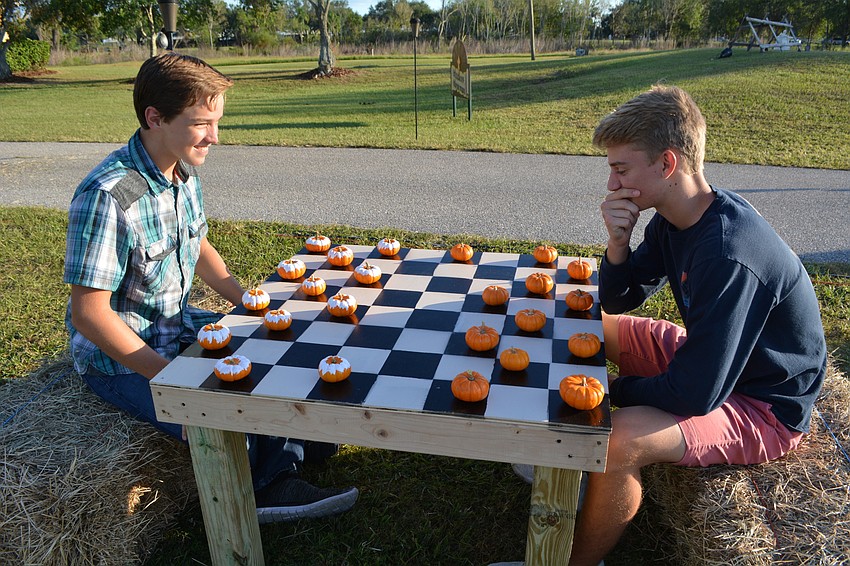 Panther Ridge's Hayden Ross and Camden Martin play a pre-show game of checkers with pumpkins as game pieces.