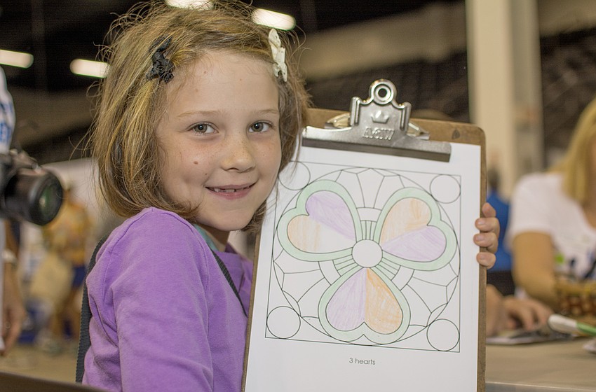Alethia Sexton poses with a picture she colored during Sarasota's Age Friendly Festival.