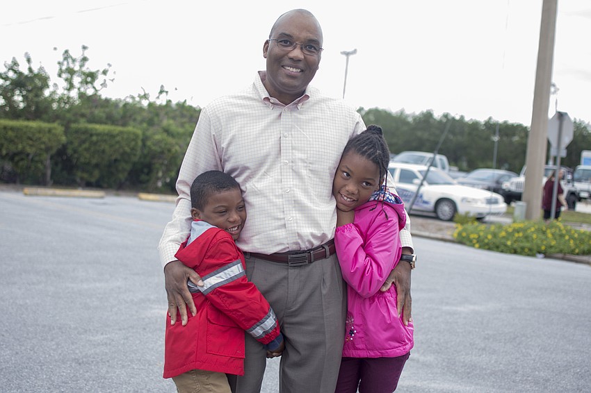 Assistant County Administrator Mark Cunningham poses with children Grant and Nadia Cunningham.