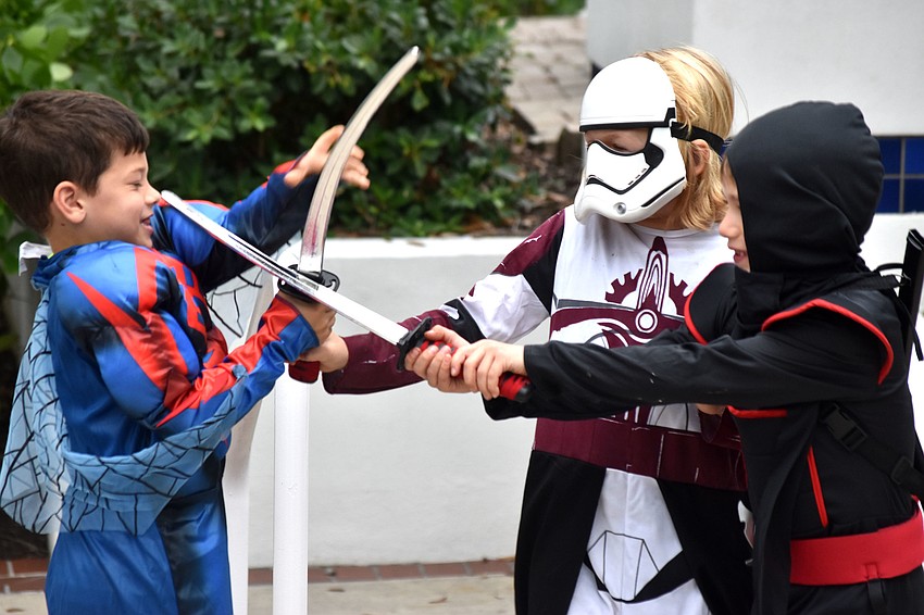 Cole Kaufman, Jackson Brester and Leo Martin battle after carving pumpkins.