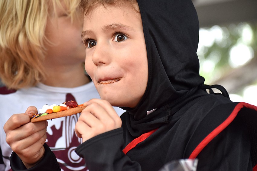 Leo Martin eats a Halloween cookie he decorated.