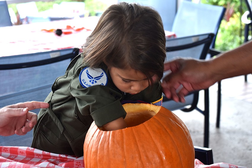 Rory Rasool digs into his pumpkin before carving it.