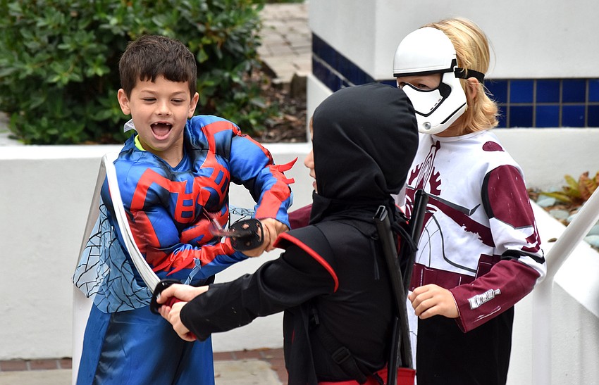 Cole Kaufman, Jackson Brester and Leo Martin battle after carving pumpkins.