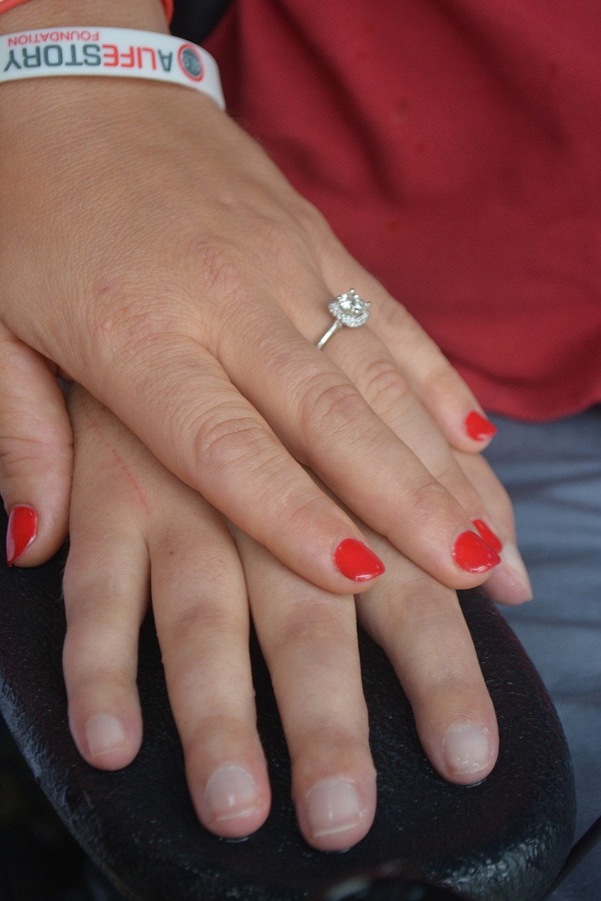 Between tears, Shaina slipped on her ring and held the hand of her fiancé.