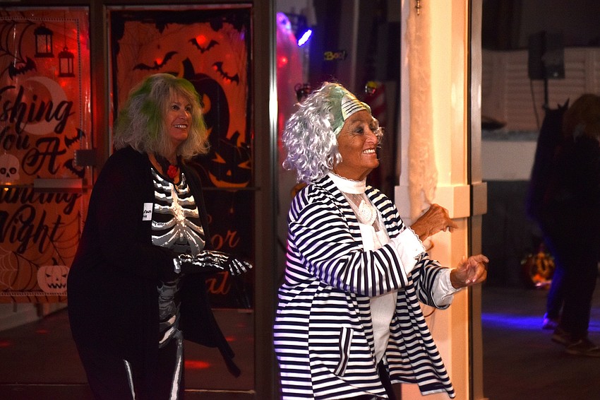 Pam O’Halloran and Connie Haubert dance to Halloween-themed songs.
