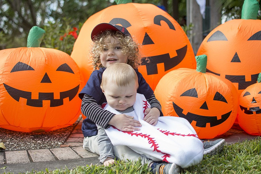 George and Louis Griffith pose with the inflatable pumpkins at the Marie Selby Botanical Gardens Spooktacular.