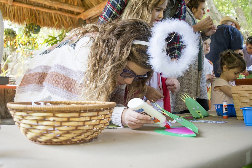 Lucia Paz makes a carnivorous plant in the craft corner at the Marie Selby Botanical Gardens Spooktacular.