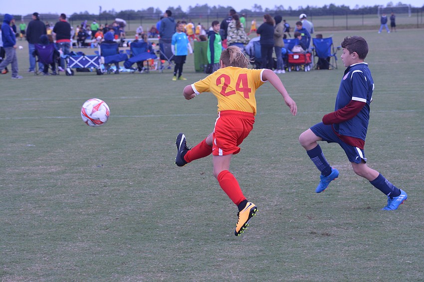 Joshua Rosenberg, playing for the U10 Lakewood Ranch Chargers, booms the ball into the back of the net against KHL Eduardo.