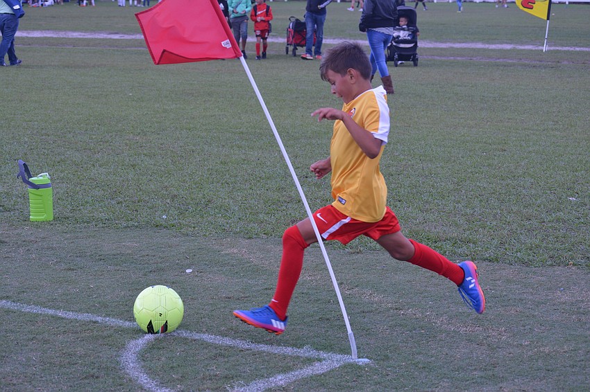 Lucas Diaz takes a corner kick for the Lakewood Ranch U9 team. The Chargers were held scoreless by Ives Estates.