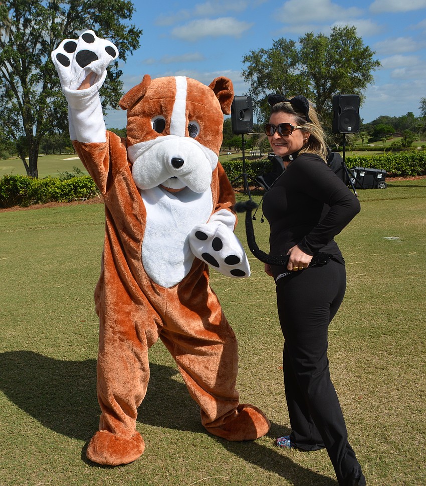 Dogs and cats dancing together? Yes, it happens at Putts Fore Mutts. Humane Society Treasurer Christine Legge wore the dog suit and that's volunteer Regina Marsh in her cat outfit.