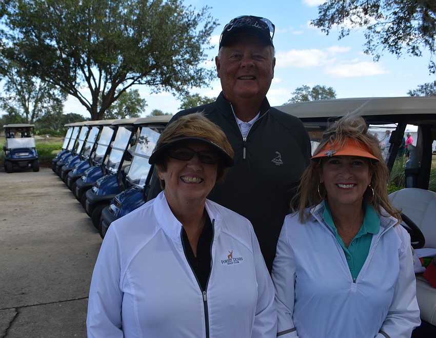 Lakewood Ranch's Alice Young, Dave Young and Jill Wellinger get ready to board their carts and head out on the course.