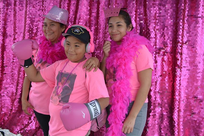 Laticia, Alex and Jenecy Alvarado, of Bradenton, pose in a Hello Gorgeous Photo Booth. They walked in memory of relative Petra Sanchez de Alvarado.