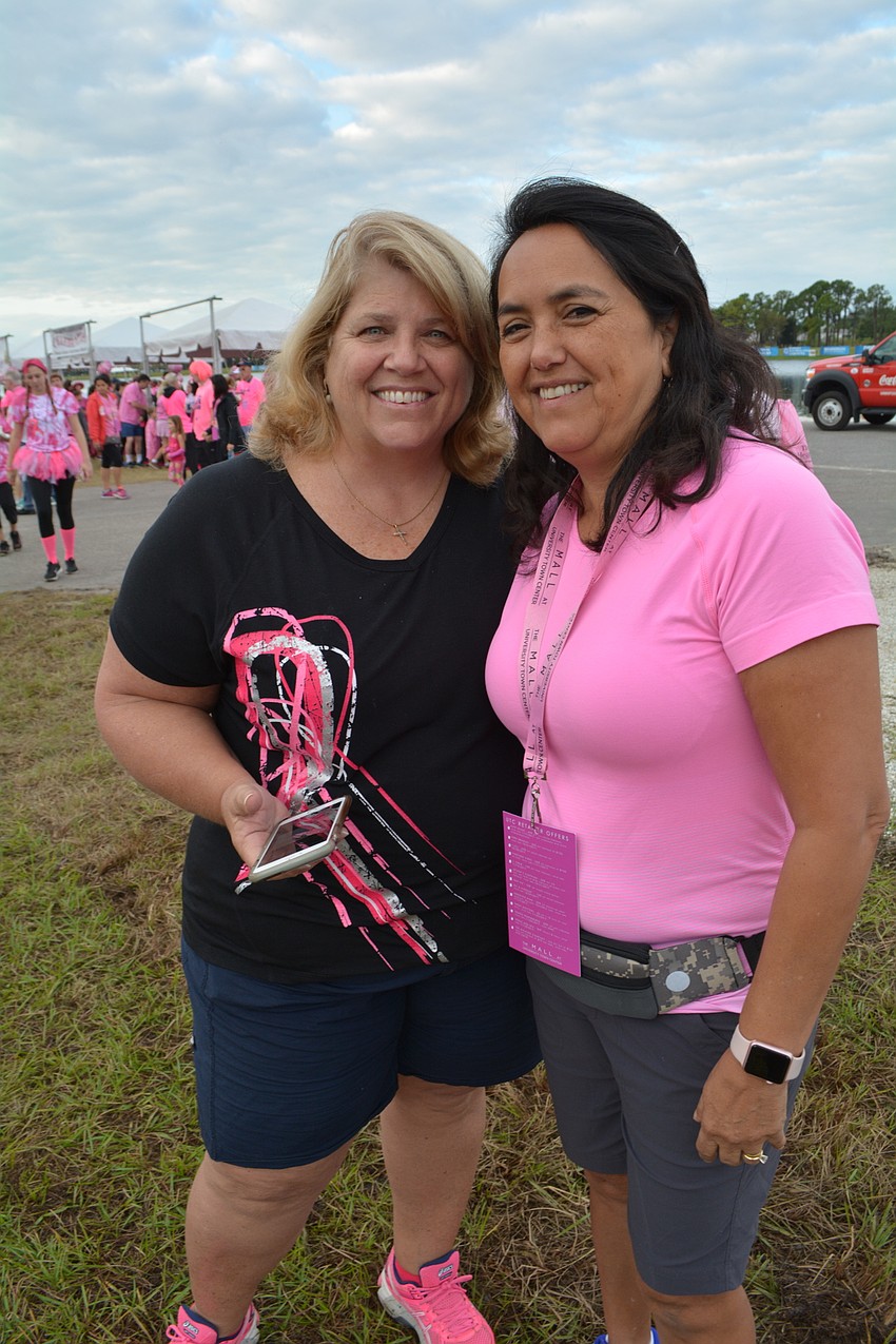Sarasota's Pam Kelly is joined by East County's Gina Medred on her Breast Friends Parade team.