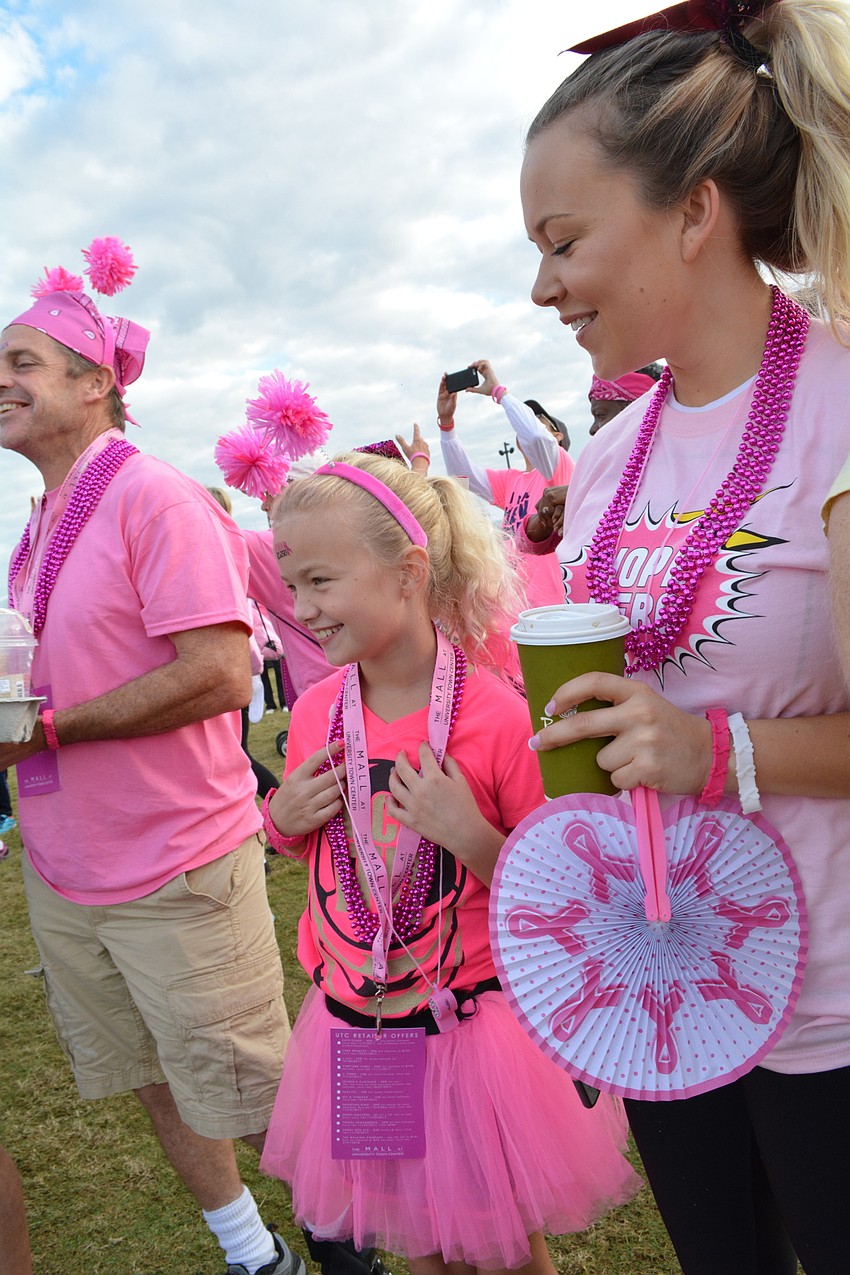 Taylor Grant, center, smiles as she watches a flash mob perform.