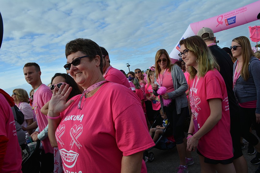Nancy Kulaga, of Saraota, waves to the camera as she starts the walk.