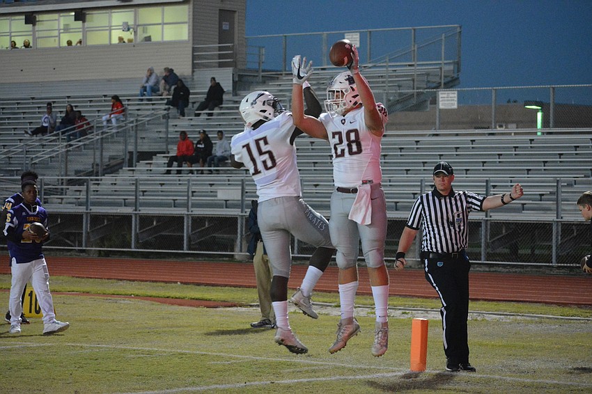 Braden River's Knowledge McDaniel and Travis Tobey celebrate Tobey's first-quarter touchdown pass.