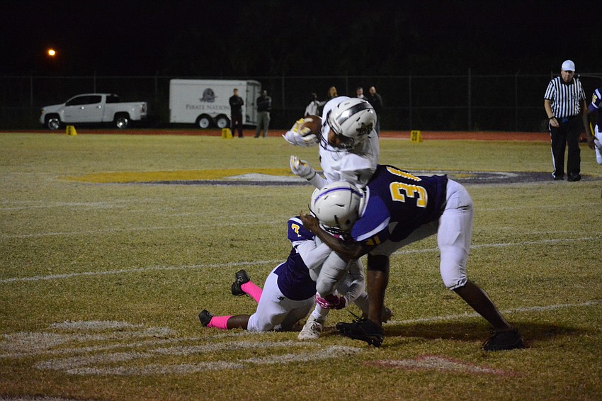 Braden River's Craivon Koonce gets crunched by Booker's Jeremiah Davis (31).