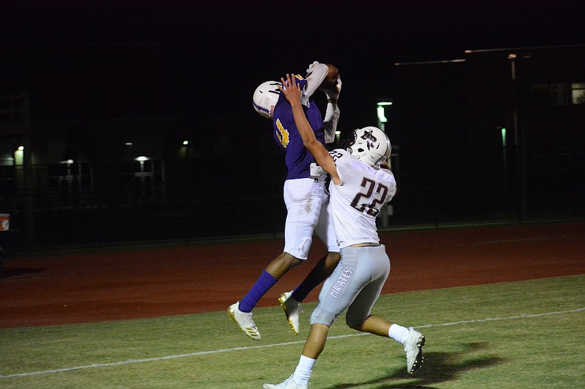 Booker wideout and University of South Florida verbal commit Talik Keaton skies over Braden River's Tyler Navas for a late touchdown catch.