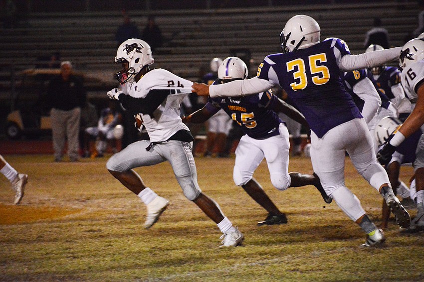Braden River's Camaron White shrugs off a Booker defender's attempt to grab his jersey.