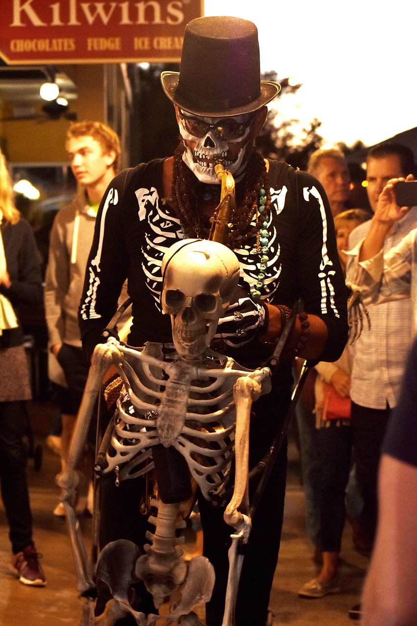 A skeleton plays jazz music as he makes his way around St. Armands.