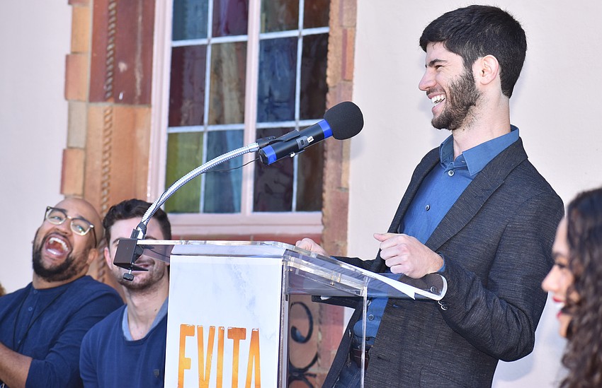 Music Director Sinai Tabak laughs while addressing the crowd about his experience with “Evita.”