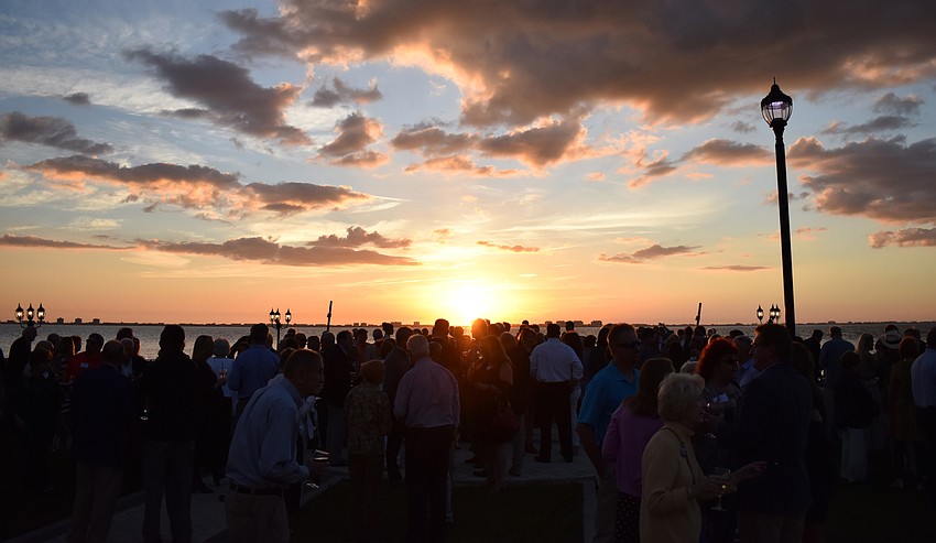 The sun set over Sarasota Bay as attendees mingled before dinner.