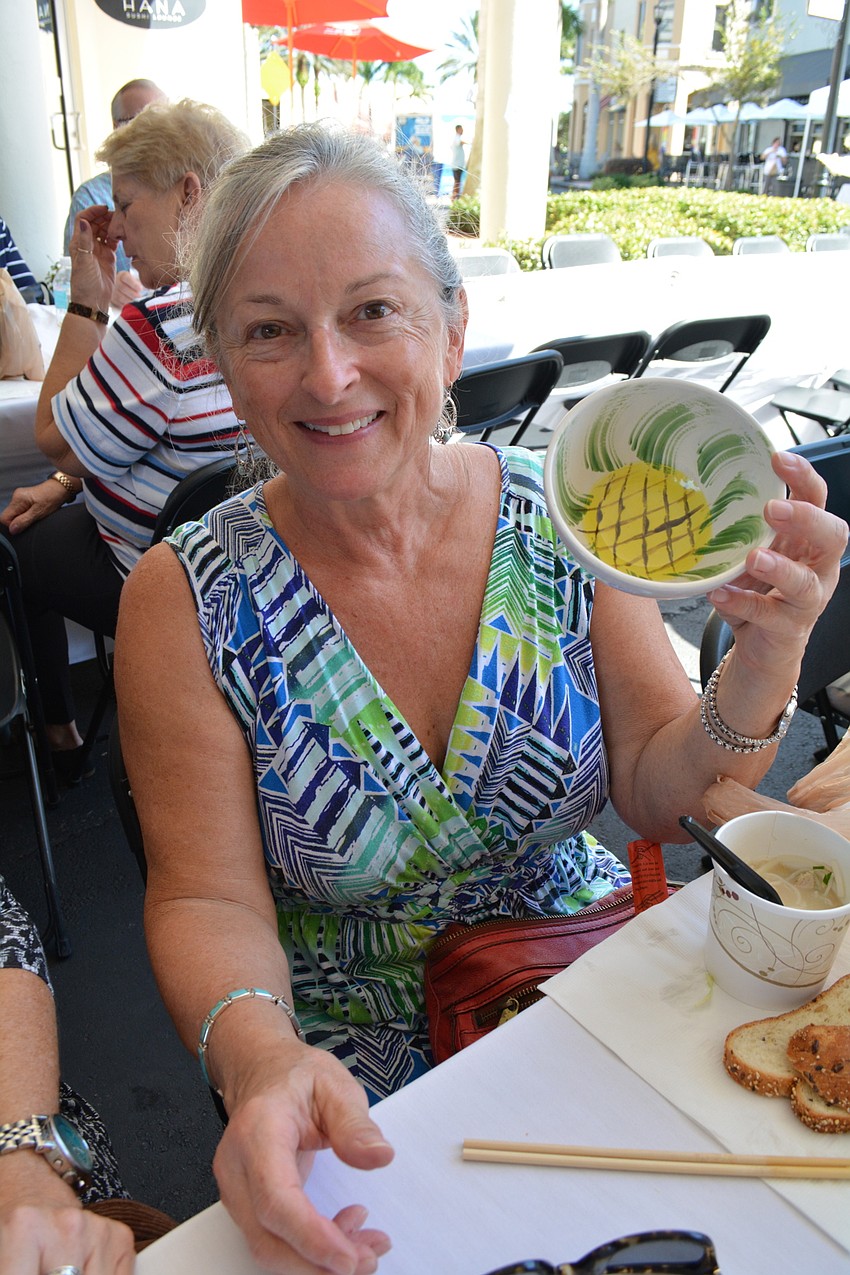 Deborah Mosher, of Sarasota, found one of the bowls she painted for the event and chose it as her souvenir bowl.