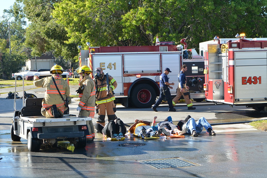 East Manatee Fire Rescue firefighters deliver critical patients to a pre-HAZMAT area so they can be rinsed of chemicals from a chlorine bomb.
