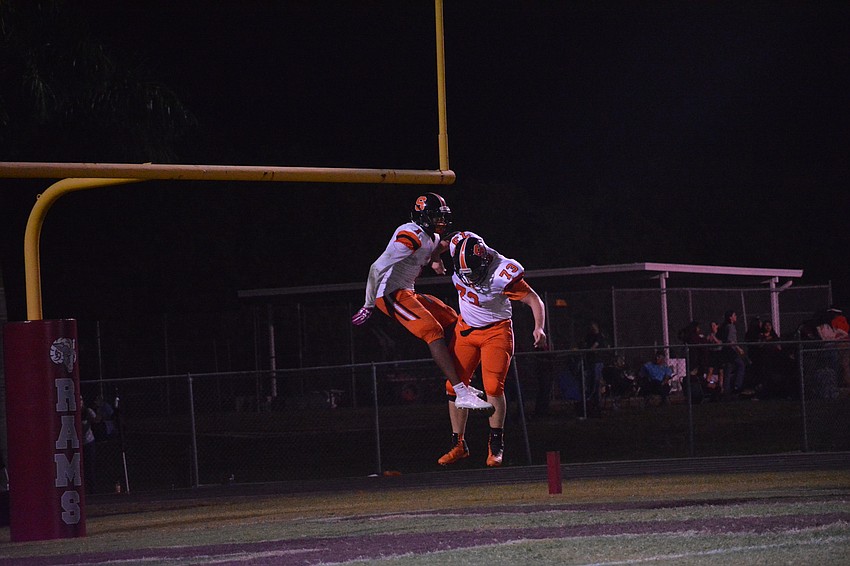The Sailors' Charles Ward and Robert Luce celebrate Ward's touchdown.