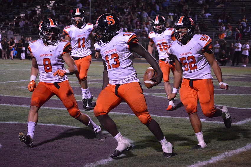The Sailors' Roshon Mae (13)  celebrates his fumble recovery-turned-touchdown late in the game.