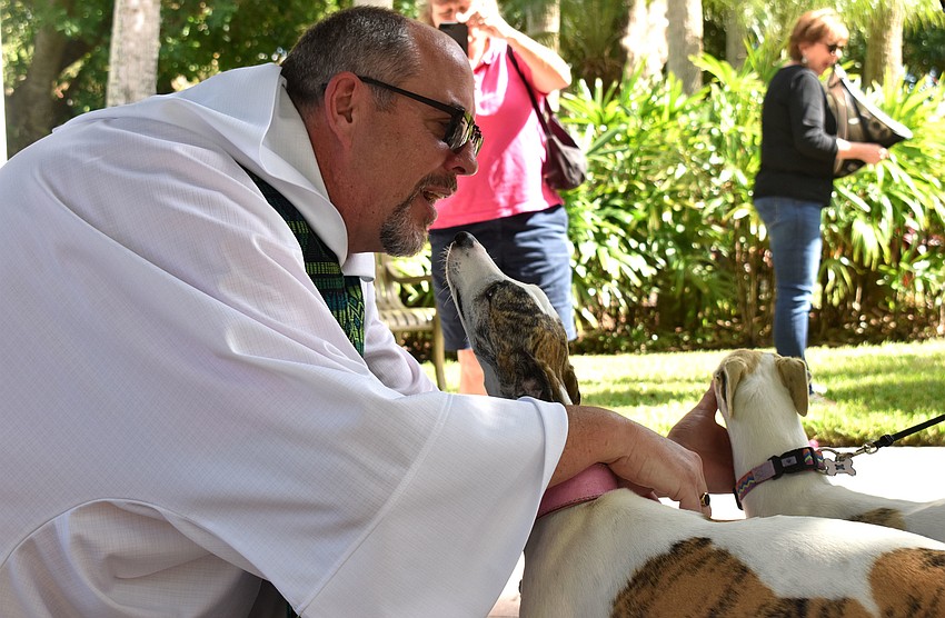 The Rev. Ken Blyth blesses Emma and Bella.