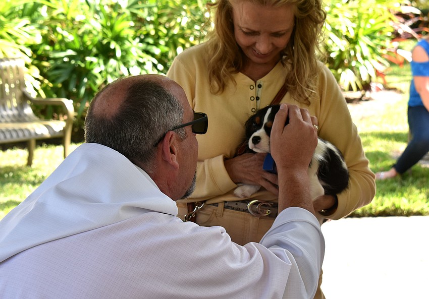 The Rev. Ken Blyth blesses Mercedes during the St. Armands Key Lutheran Church pet blessing.