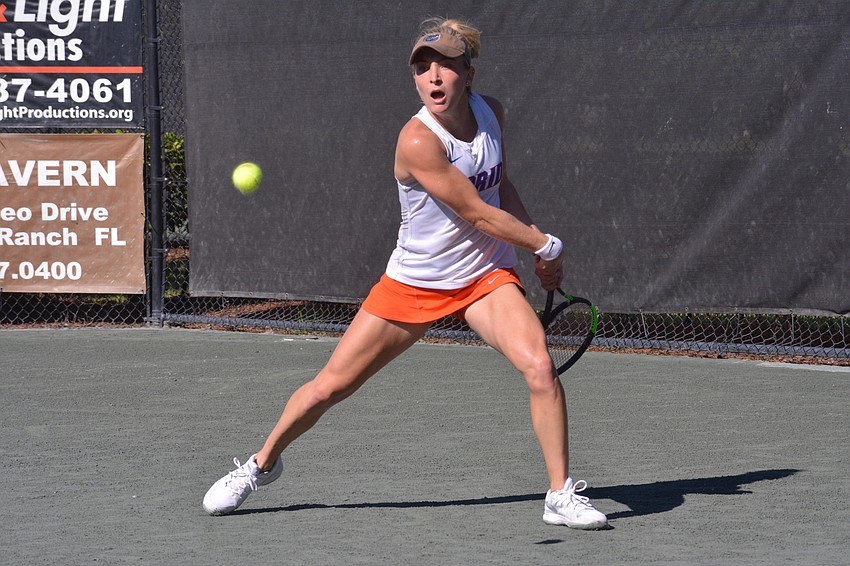 Josie Kuhlman stretches to get in position for a backhand shot. She won the women's singles title 6-2, 6-3.
