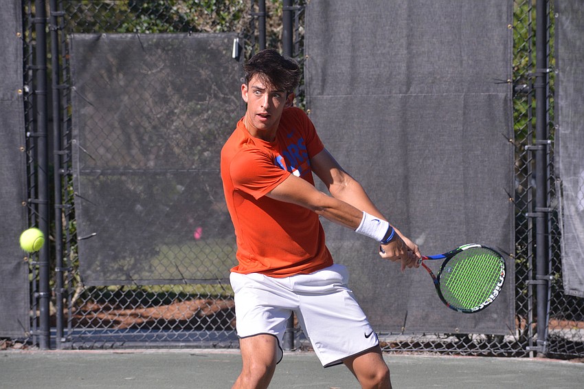 Florida's Andy Andrade exerts all his energy to hit a backhand shot.