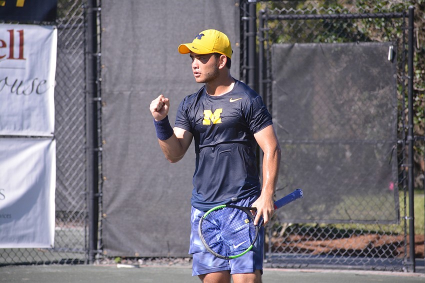 Michigan's Carter Linn pumps his fist after he and partner Kristofer Siimar won a point in the men's doubles title match. The pair won the match 8-4.