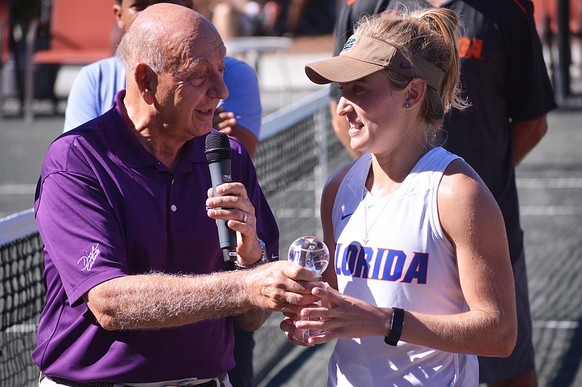 Dick Vitale presents Florida's Josie Kuhlman with her women's singles title.