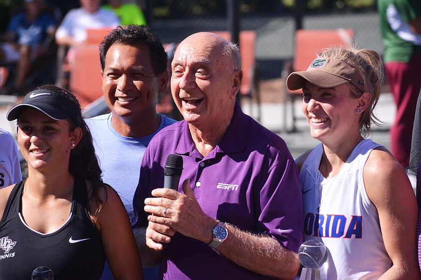 Central Florida's Monica Matias, tournament co-founder Chris Marquez, Dick Vitale and Florida's Josie Kuhlman pose for pictures following the women's singles championship match.