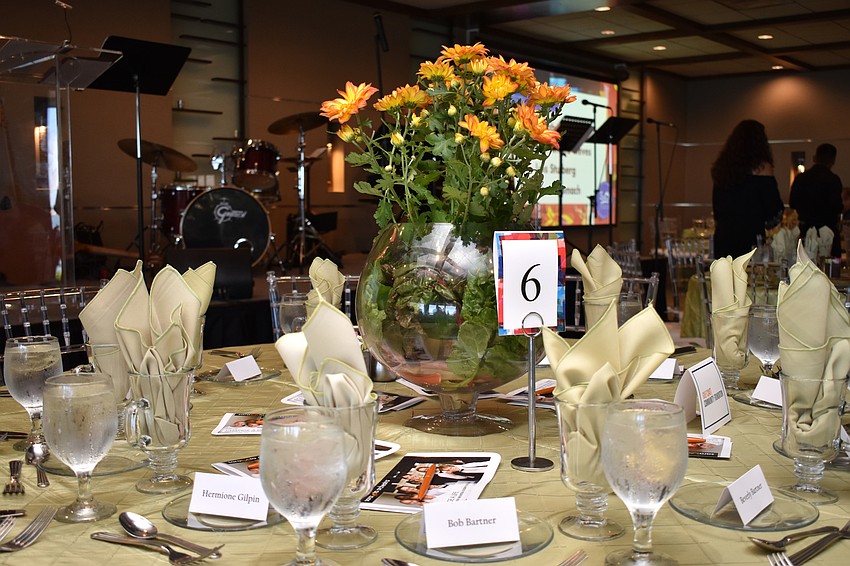 A floral centerpiece adorned every table.