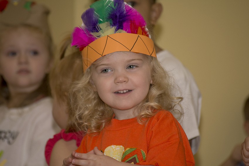 Cora Young smiles while performing for Temple Emanu-El preschool parents and staff during the school's Thanksgiving pageant.