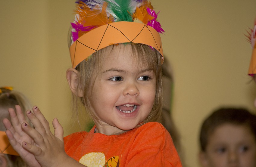 Olivia Chupp applauds after performing for Temple Emanu-El preschool parents and staff during the school's Thanksgiving pageant.