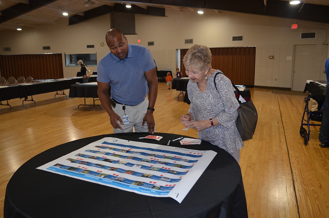 Parks and Recreation Director Jerry Fogle discusses recreation opportunities with resident Jude Levy at Payne Park Auditorium on Saturday.