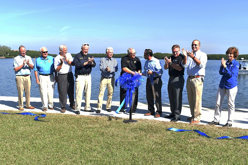 Officials from the Town of Longboat Key and Sarasota County cut the ribbon to mark the official opening of Bayfront Park.