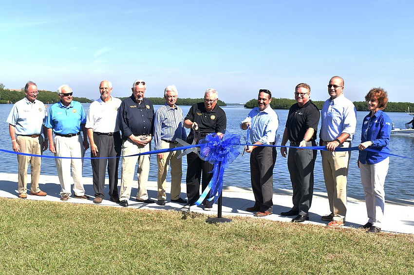 Officials from the Town of Longboat Key and Sarasota County cut the ribbon to mark the official opening of Bayfront Park.