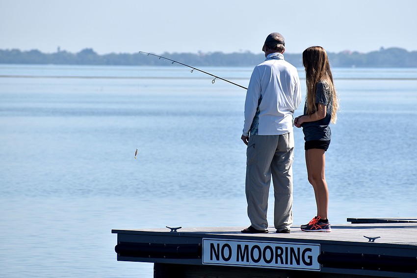 Rusty Chinnis gives a fishing lesson at the Bayfront Park grand opening.