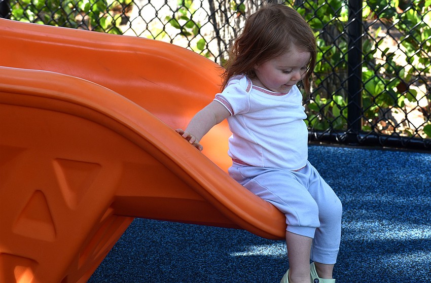 Lily Haas tests out the slide at the children’s playground at Bayfront Park.