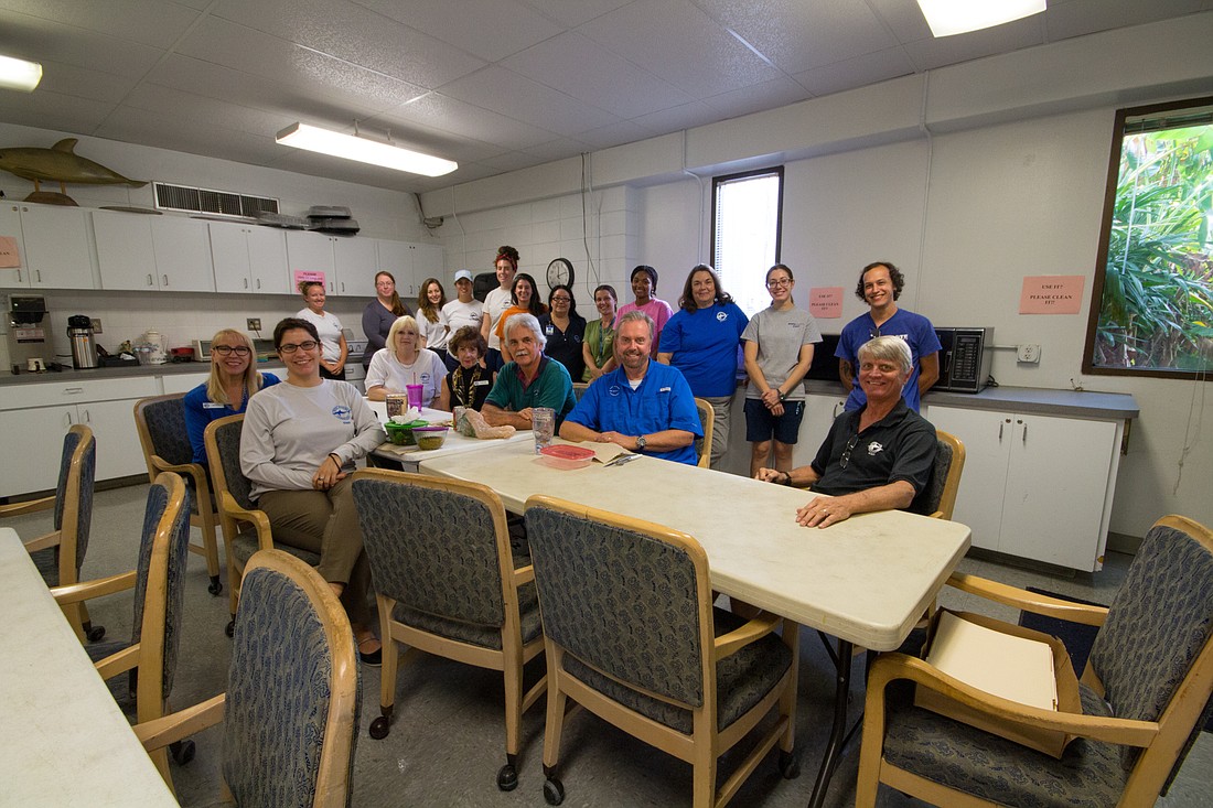 Mote employees pose in the break room set to get $50,000 in upgrades.