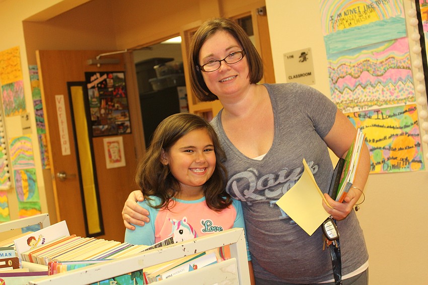 Braden River Elementary second-grader Miranda McRee and her mom, Amanda McRee, select books.