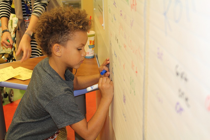 Braden River Elementary first-grader Raeden Godbolt plays a word search game.